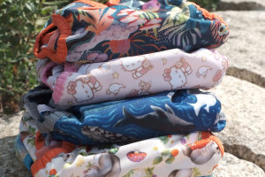 stack of 5 colourful cloth nappies