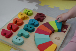 Rainbow colored wooden puzzle with numbers