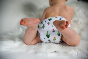 baby lying on a wool rug